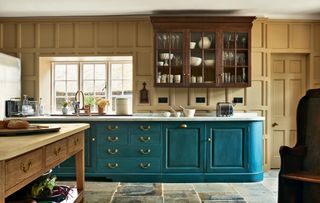 Image may contain Furniture Indoors Room Cabinet Kitchen Island China Cabinet Interior Design Kitchen and Shelf