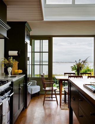 Image may contain Furniture Chair Room Indoors Wood Flooring Interior Design Kitchen Hardwood and Plant