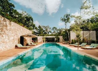 Image may contain Architecture Building House Housing Villa Pool Water Swimming Pool Plant Hotel and Resort