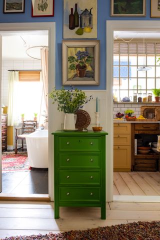 Image may contain Furniture Interior Design Indoors Cabinet Room Dresser Sideboard Vase Plant and Pottery