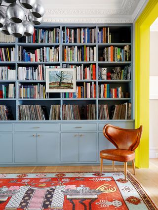 Image may contain Furniture Bookcase Rug Indoors and Room