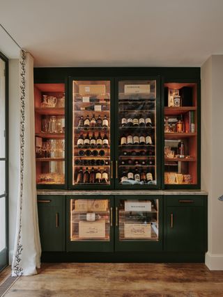 The bespoke wine unit in this classic and colourful Chelsea townhouse was made by Rupert Bevan.