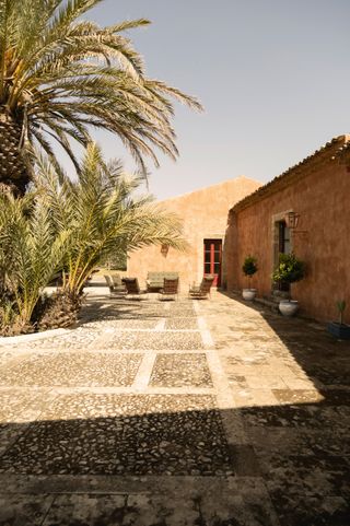 Image may contain Architecture Building House Housing Villa Plant Floor Lamp Chair Furniture and Outdoors